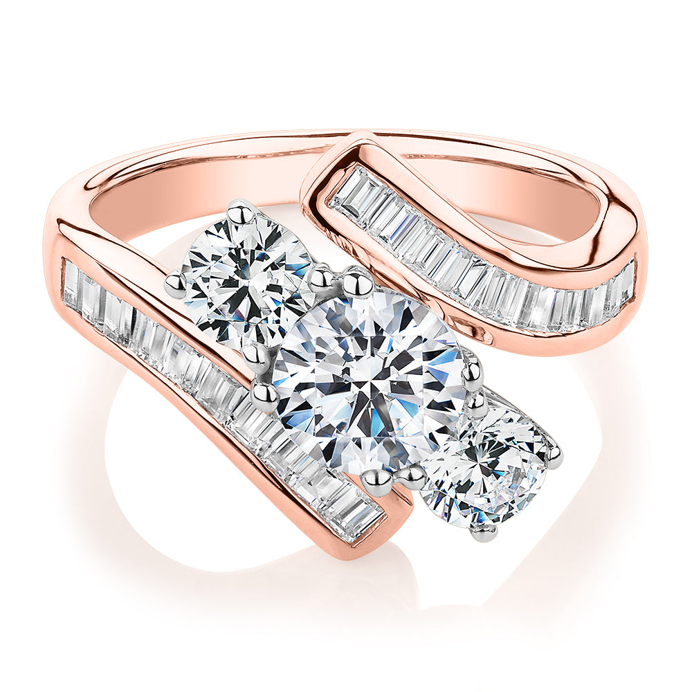 Three stone ring with 2.63 carats* of diamond simulants in 10 carat rose and white gold