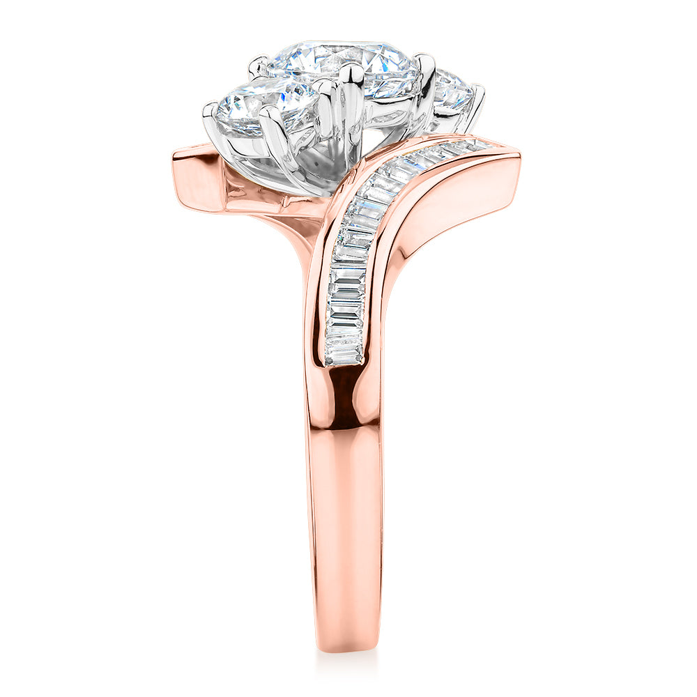 Three stone ring with 2.63 carats* of diamond simulants in 10 carat rose and white gold