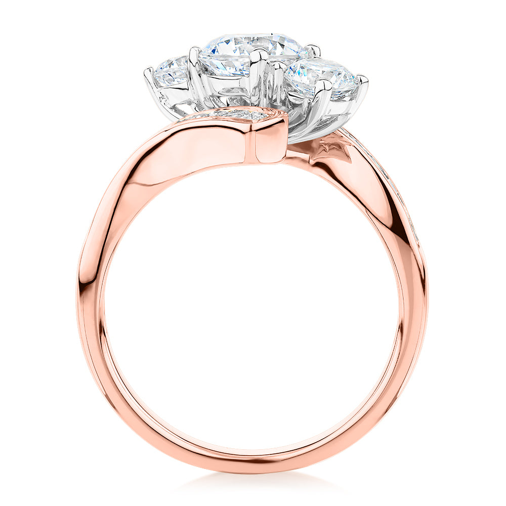 Three stone ring with 2.63 carats* of diamond simulants in 10 carat rose and white gold