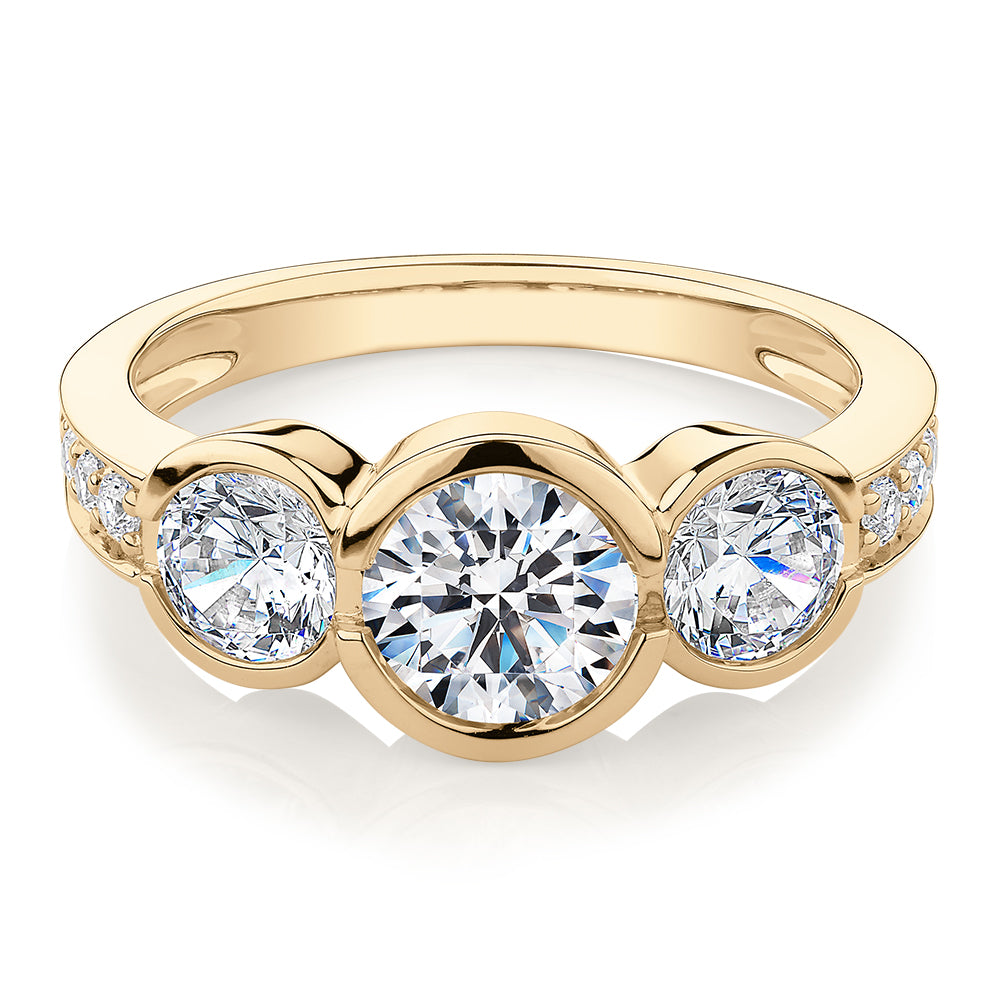 Three stone ring with 2.11 carats* of diamond simulants in 10 carat yellow gold