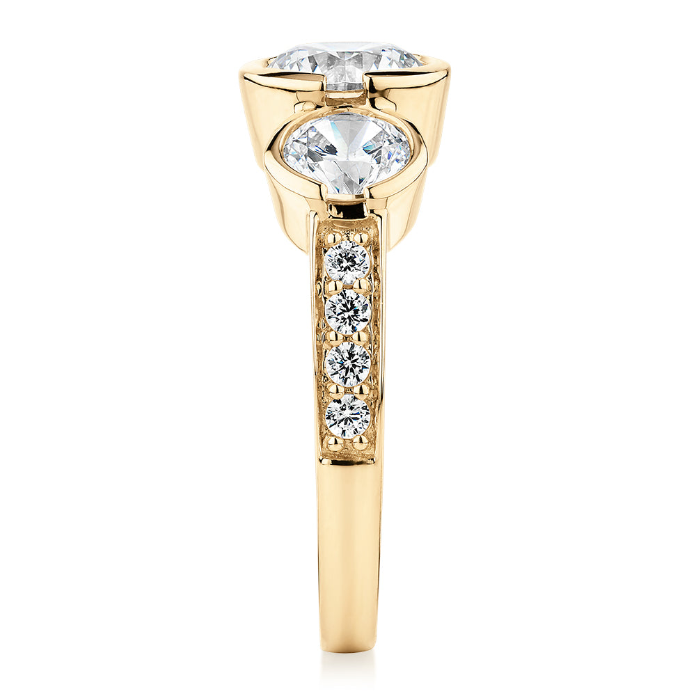 Three stone ring with 2.11 carats* of diamond simulants in 10 carat yellow gold
