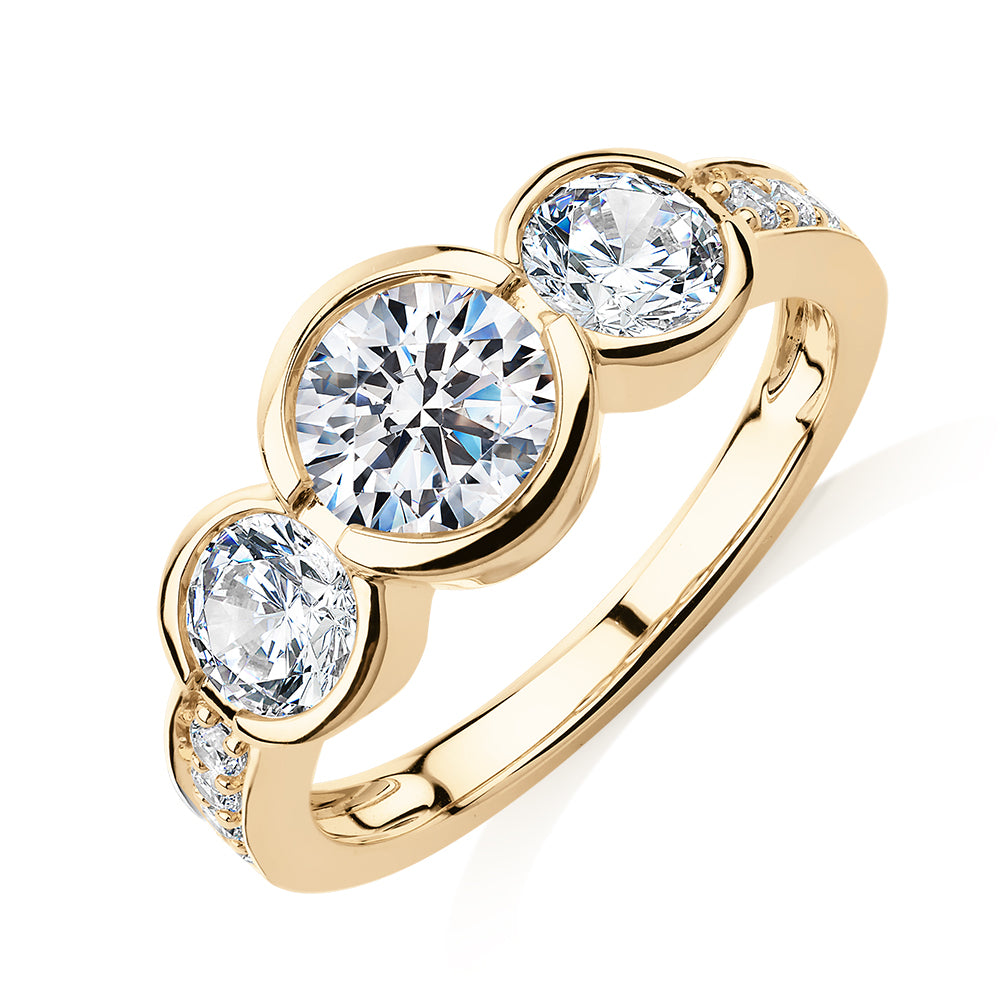 Three stone ring with 2.11 carats* of diamond simulants in 10 carat yellow gold