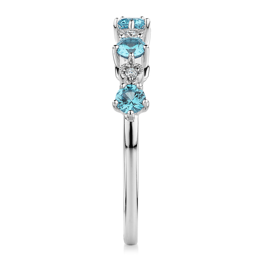 Wedding or eternity band with blue topaz and diamond simulants in 10 carat white gold