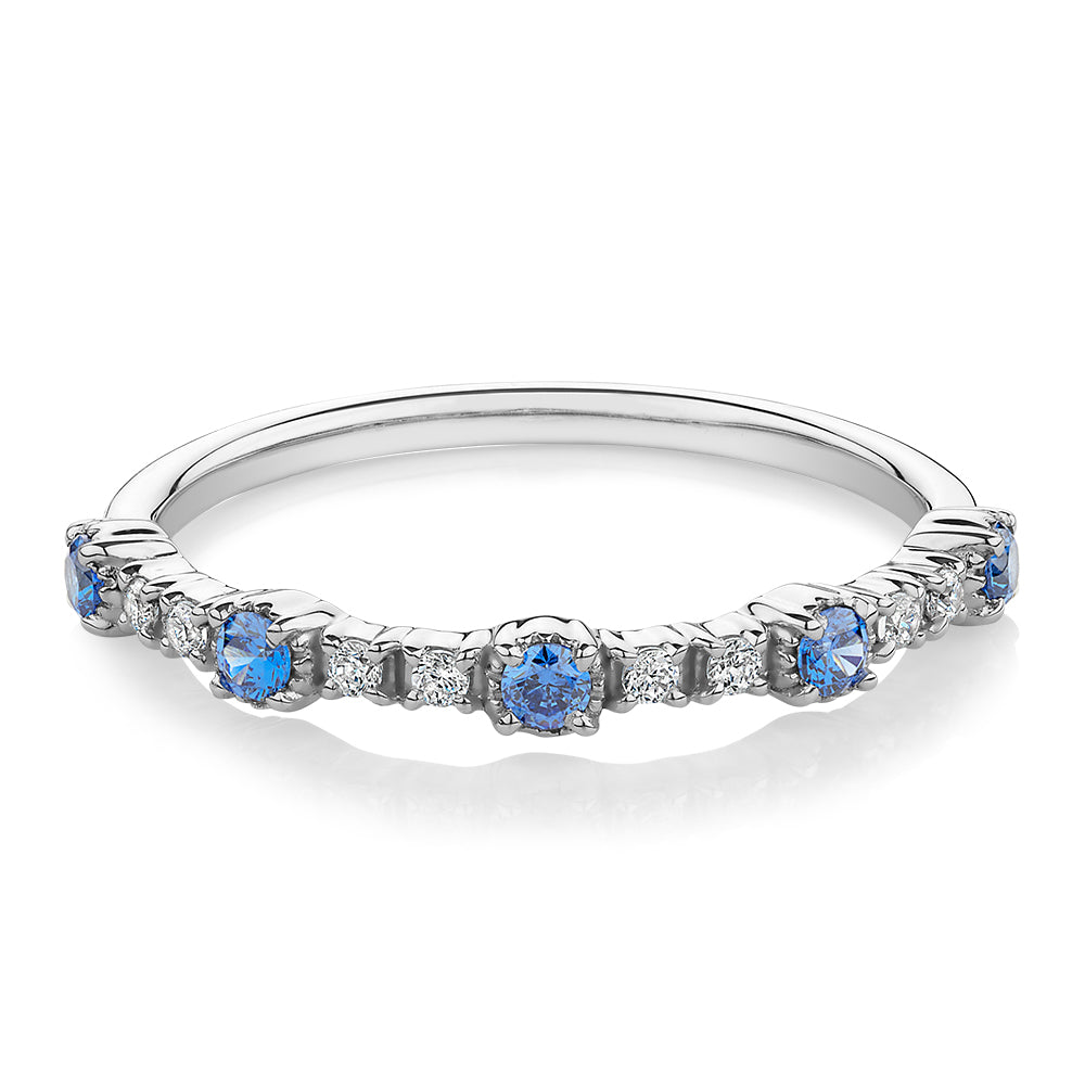 Wedding or eternity band with blue topaz and diamond simulants in 10 carat white gold