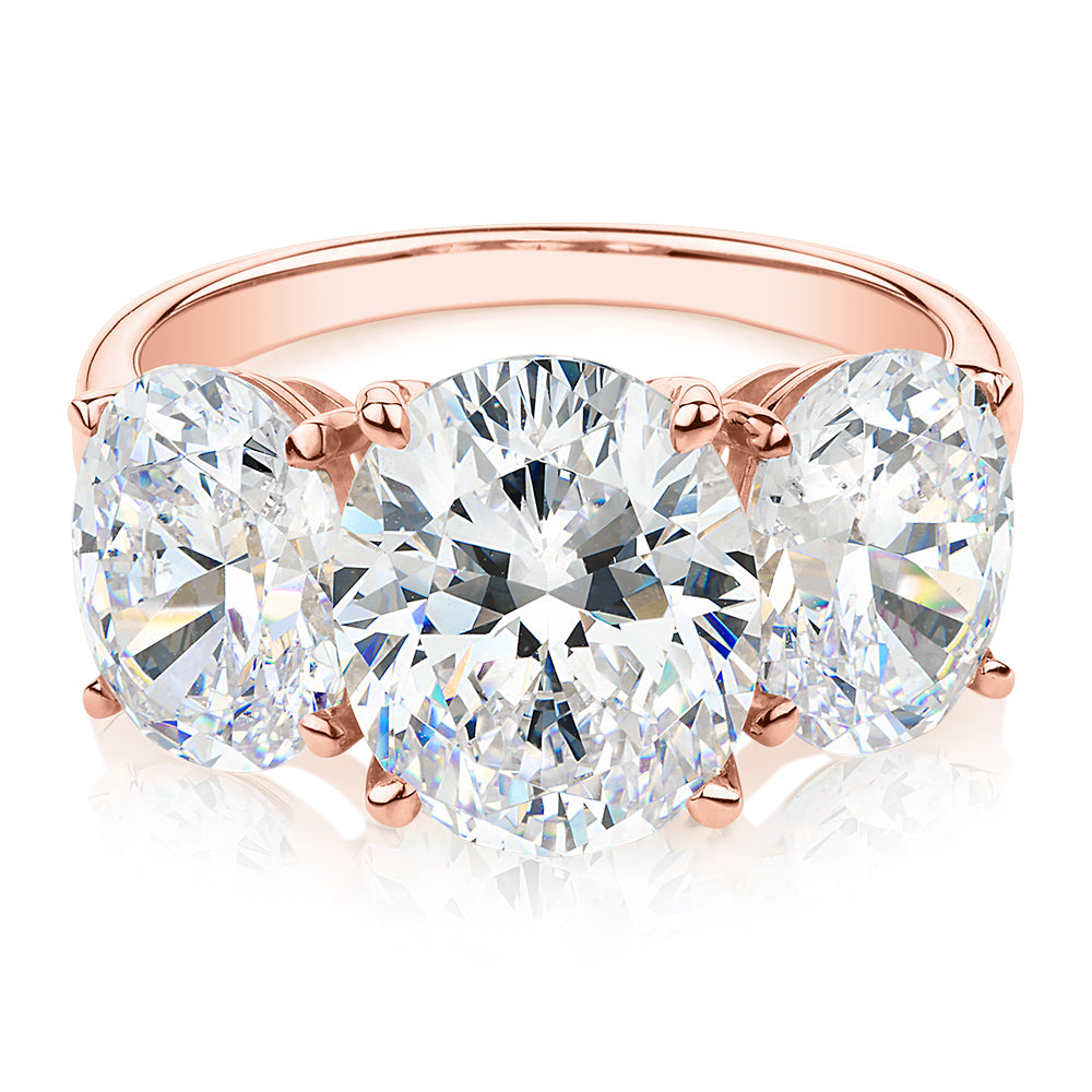 Three stone ring with 7.57 carats* of diamond simulants in 10 carat rose gold