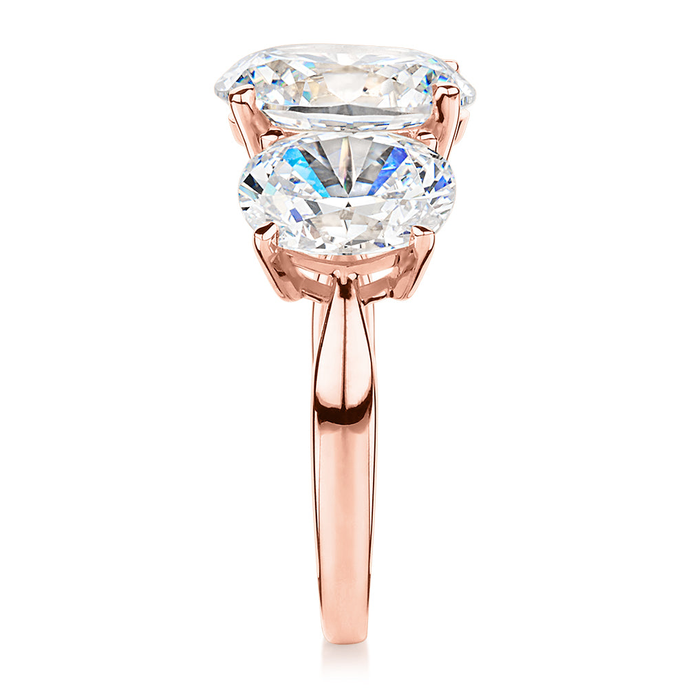 Three stone ring with 7.57 carats* of diamond simulants in 10 carat rose gold