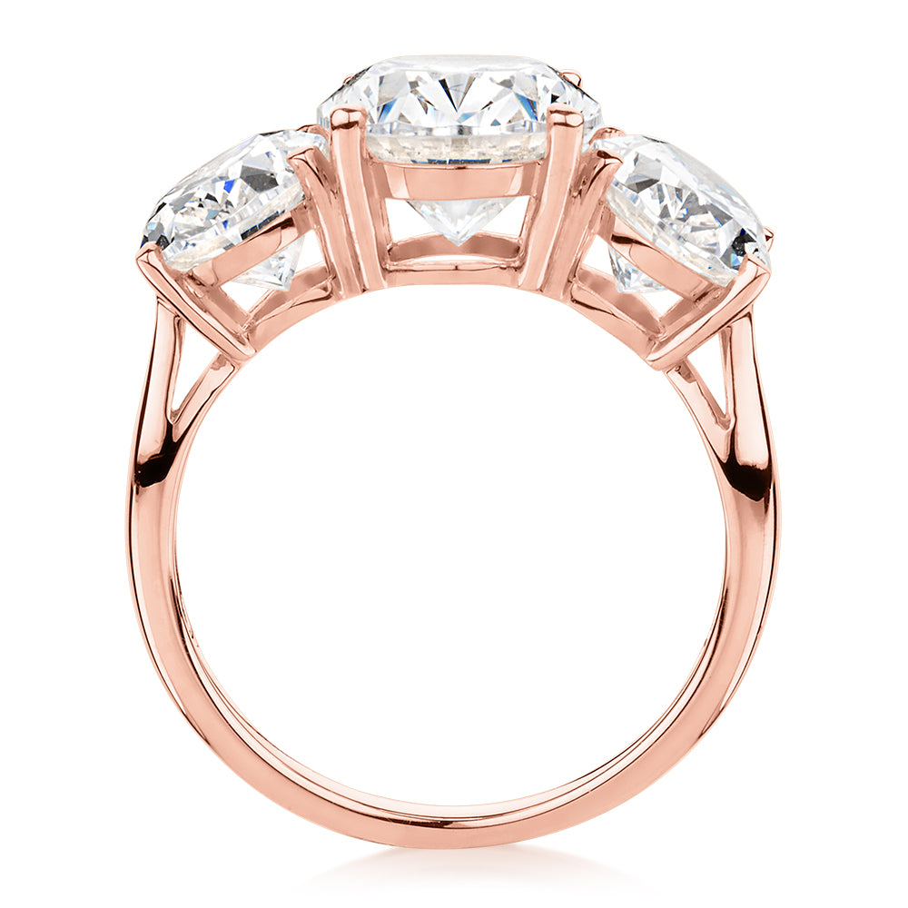 Three stone ring with 7.57 carats* of diamond simulants in 10 carat rose gold