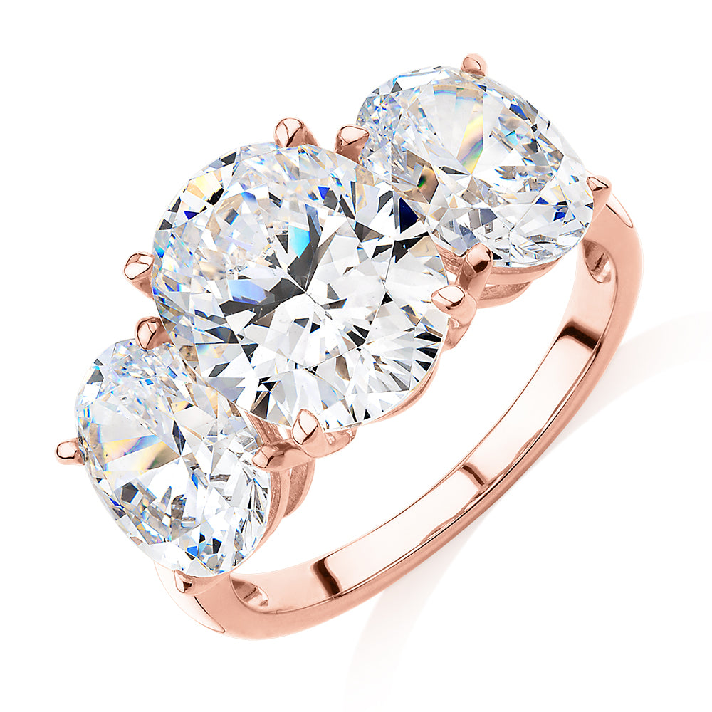 Three stone ring with 7.57 carats* of diamond simulants in 10 carat rose gold