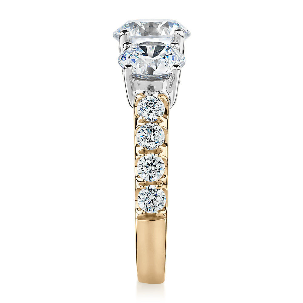 Three stone ring with 3.44 carats* of diamond simulants in 10 carat yellow and white gold