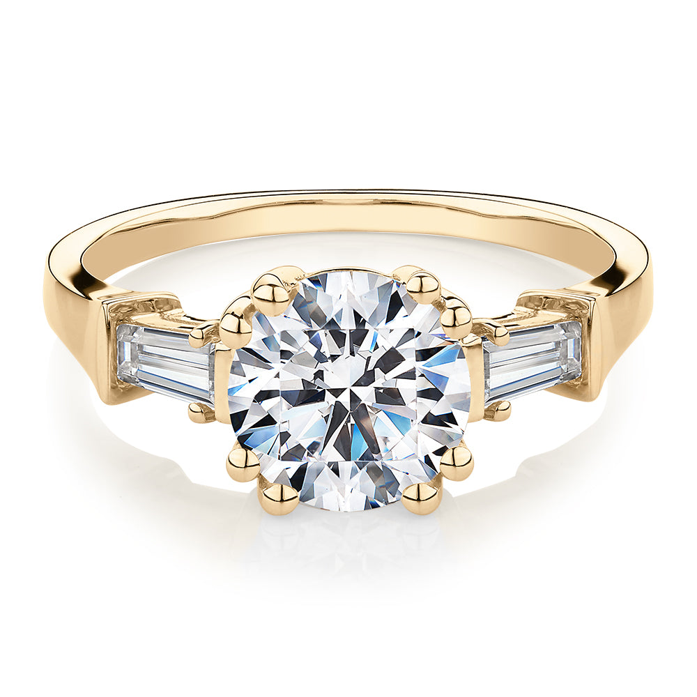 Round Brilliant and Baguette shouldered engagement ring with 2.46 carats* of diamond simulants in 10 carat yellow gold