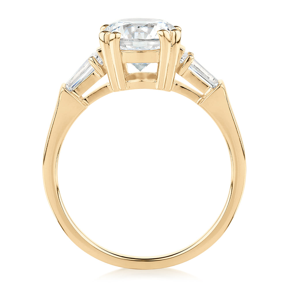 Round Brilliant and Baguette shouldered engagement ring with 2.46 carats* of diamond simulants in 10 carat yellow gold