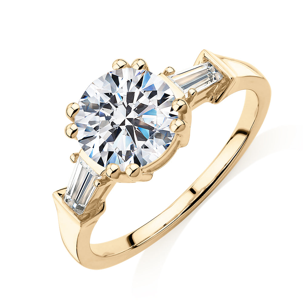 Round Brilliant and Baguette shouldered engagement ring with 2.46 carats* of diamond simulants in 10 carat yellow gold