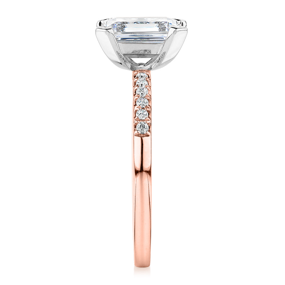 Emerald Cut and Round Brilliant shouldered engagement ring with 1.82 carats* of diamond simulants in 14 carat rose and white gold