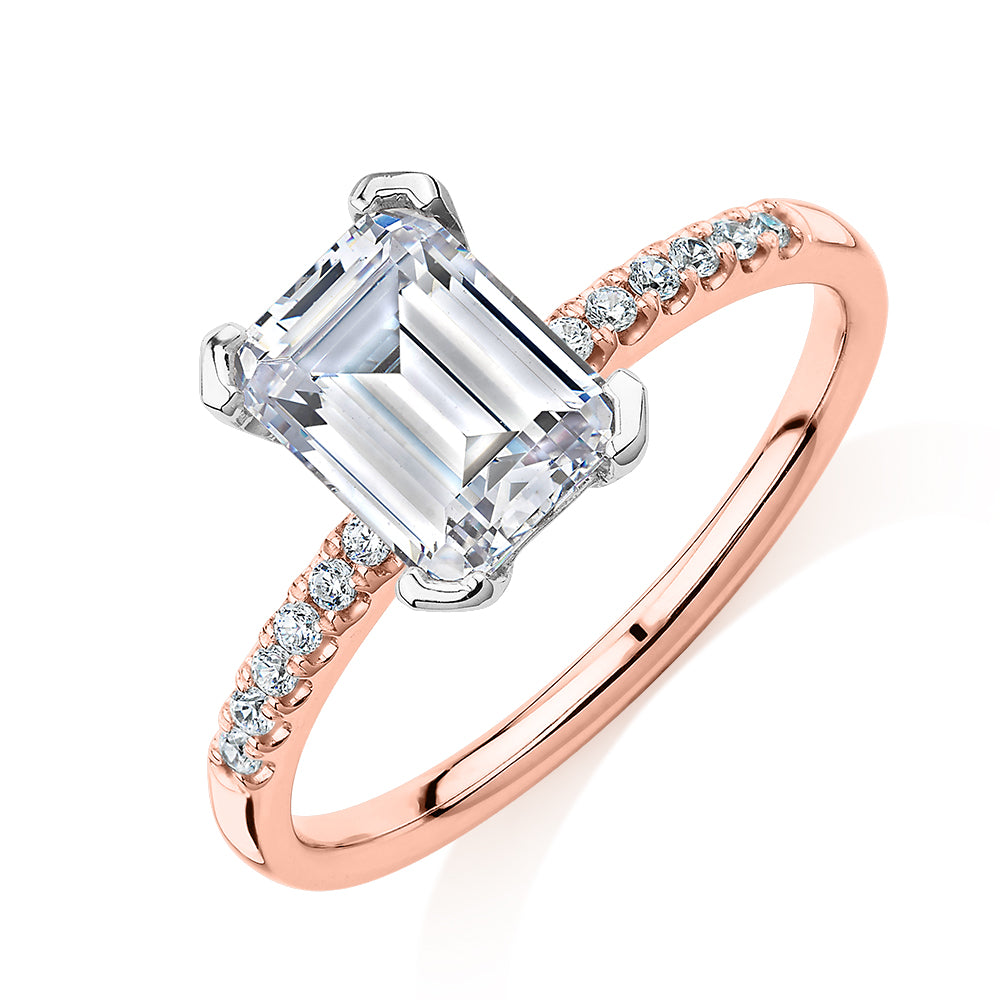 Emerald Cut and Round Brilliant shouldered engagement ring with 1.82 carats* of diamond simulants in 14 carat rose and white gold