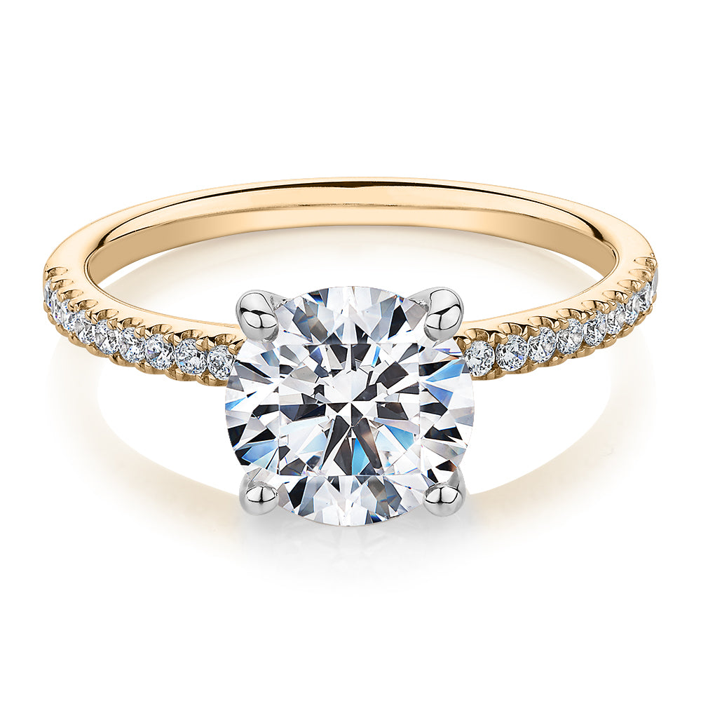 Round Brilliant shouldered engagement ring with 2.17 carats* of diamond simulants in 14 carat yellow and white gold