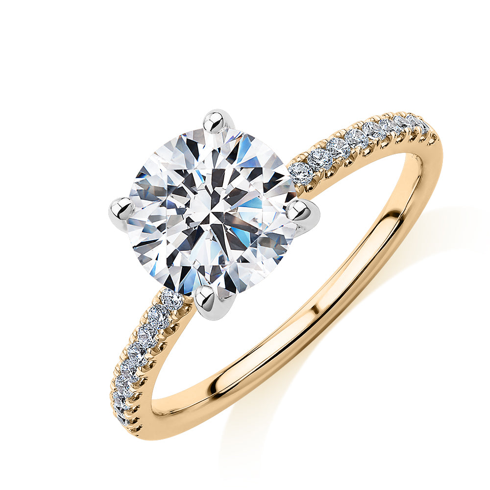 Round Brilliant shouldered engagement ring with 2.17 carats* of diamond simulants in 14 carat yellow and white gold