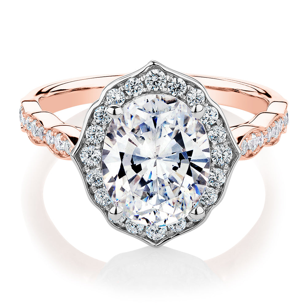 Oval and Round Brilliant halo engagement ring with 2.86 carats* of diamond simulants in 14 carat rose and white gold