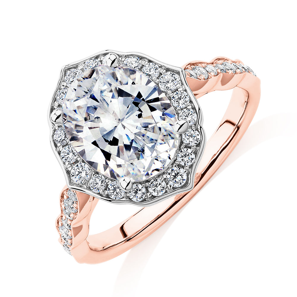 Oval and Round Brilliant halo engagement ring with 2.86 carats* of diamond simulants in 14 carat rose and white gold