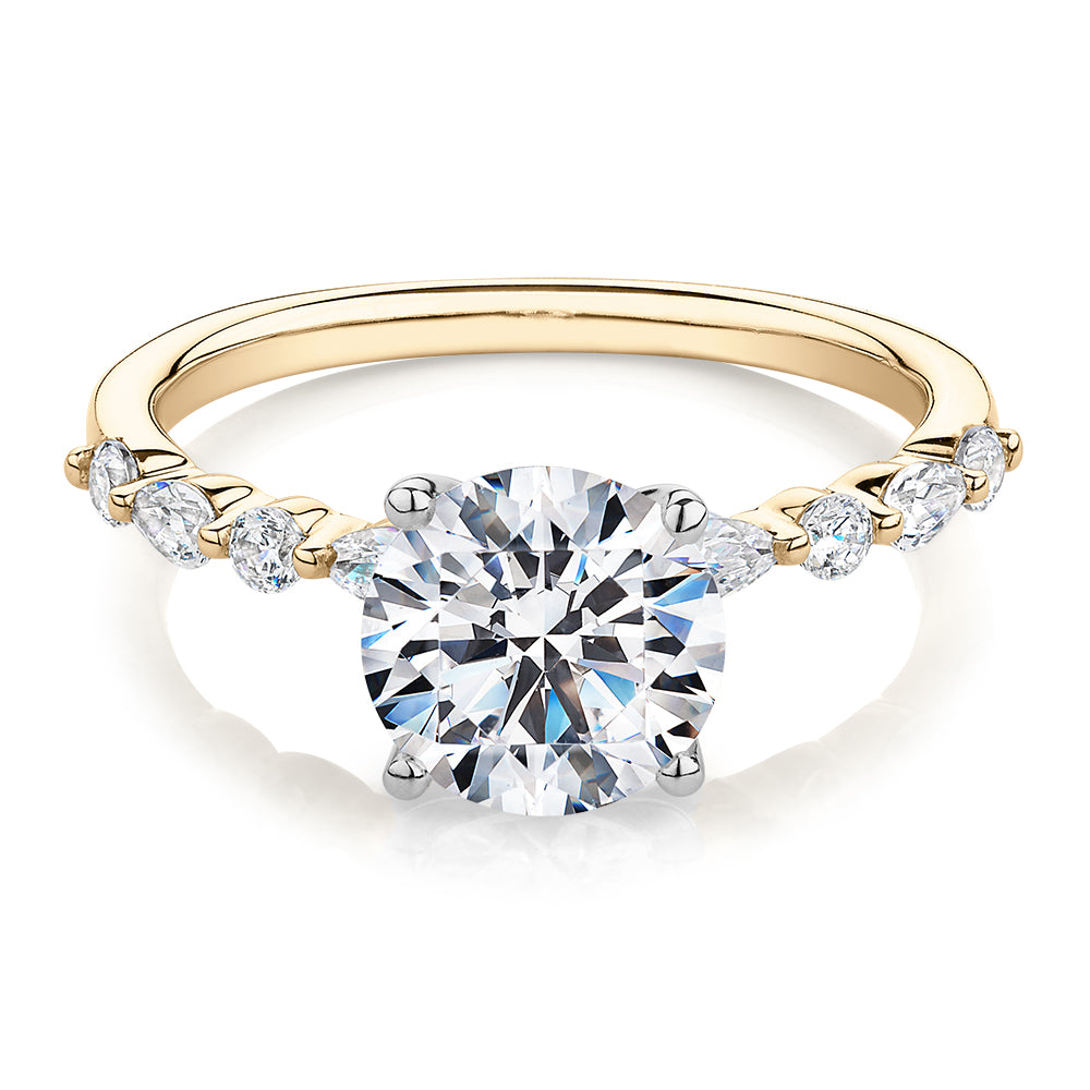 Round Brilliant and Pear shouldered engagement ring with 2.68 carats* of diamond simulants in 14 carat yellow and white gold