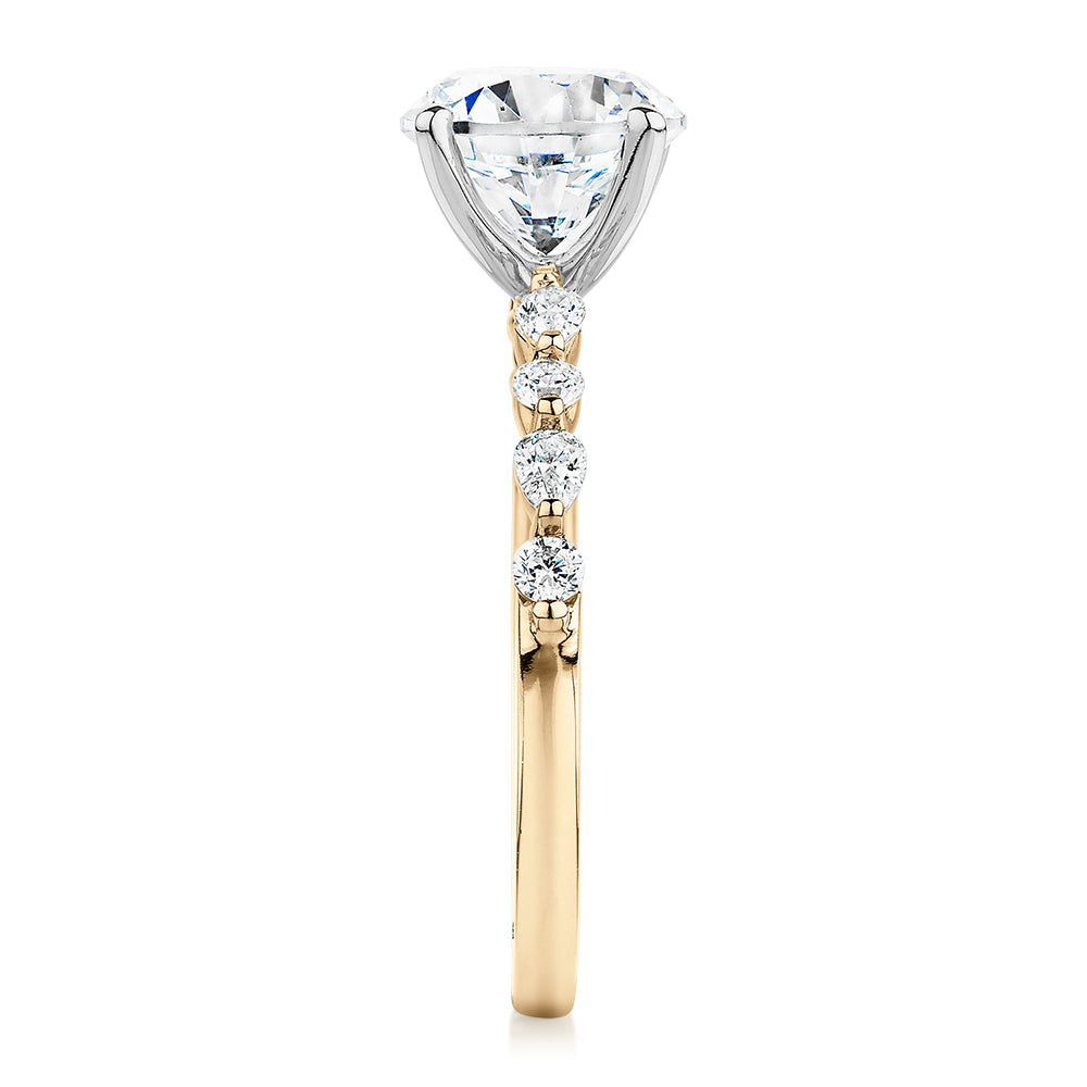 Round Brilliant and Pear shouldered engagement ring with 2.68 carats* of diamond simulants in 14 carat yellow and white gold