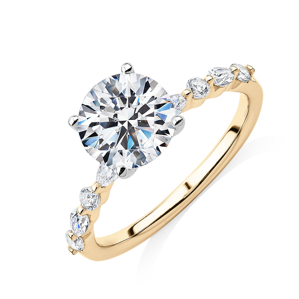 Round Brilliant and Pear shouldered engagement ring with 2.68 carats* of diamond simulants in 14 carat yellow and white gold