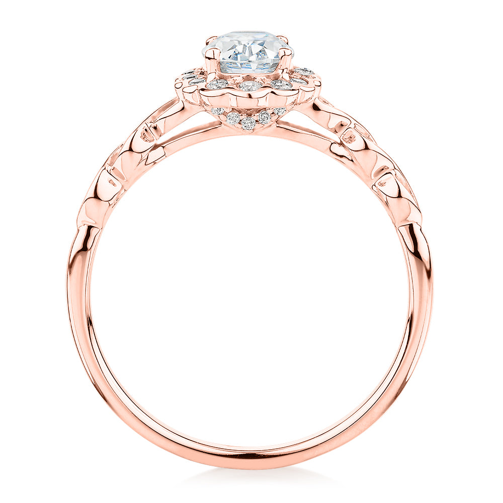 Oval and Round Brilliant halo engagement ring with 0.97 carats* of diamond simulants in 10 carat rose gold