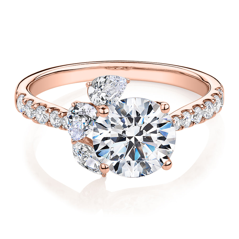 Round Brilliant and Marquise shouldered engagement ring with 2.78 carats* of diamond simulants in 14 carat rose gold