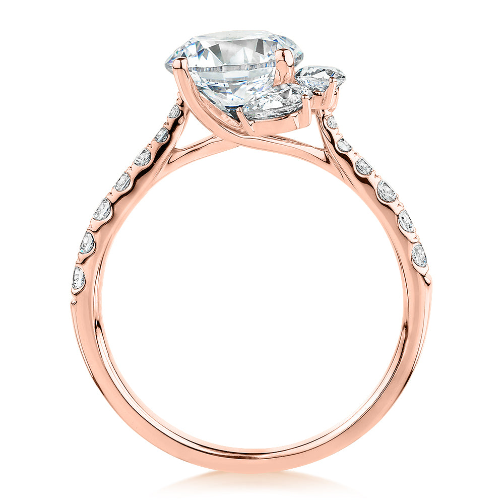 Round Brilliant and Marquise shouldered engagement ring with 2.78 carats* of diamond simulants in 14 carat rose gold