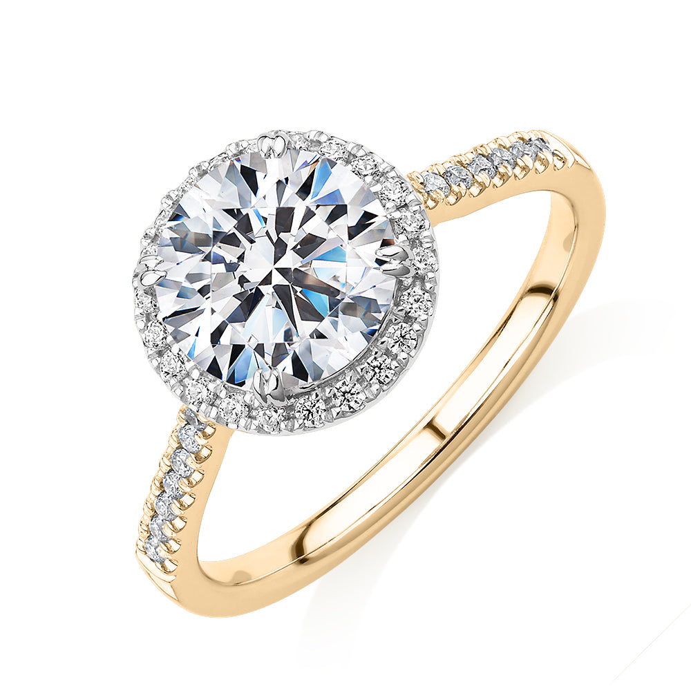 Round Brilliant halo engagement ring with 2.27 carats* of diamond simulants in 14 carat yellow and white gold