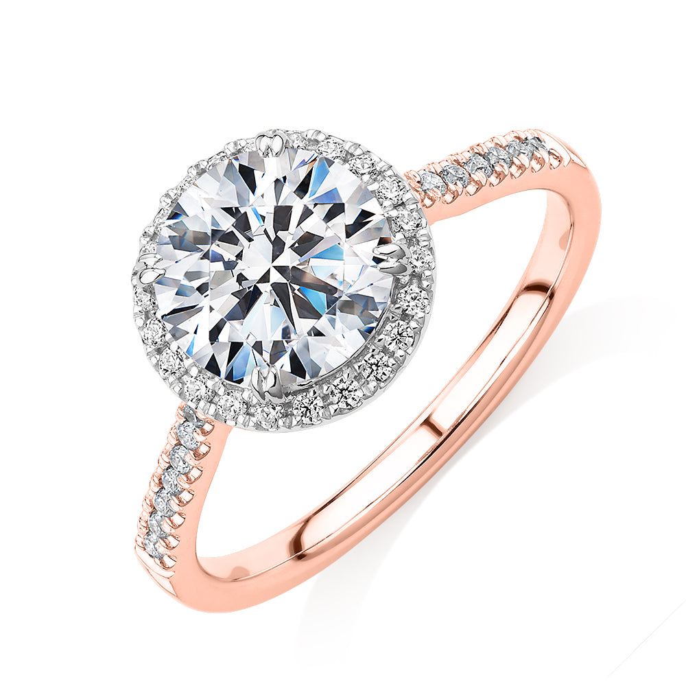 Round Brilliant halo engagement ring with 2.27 carats* of diamond simulants in 14 carat rose and white gold