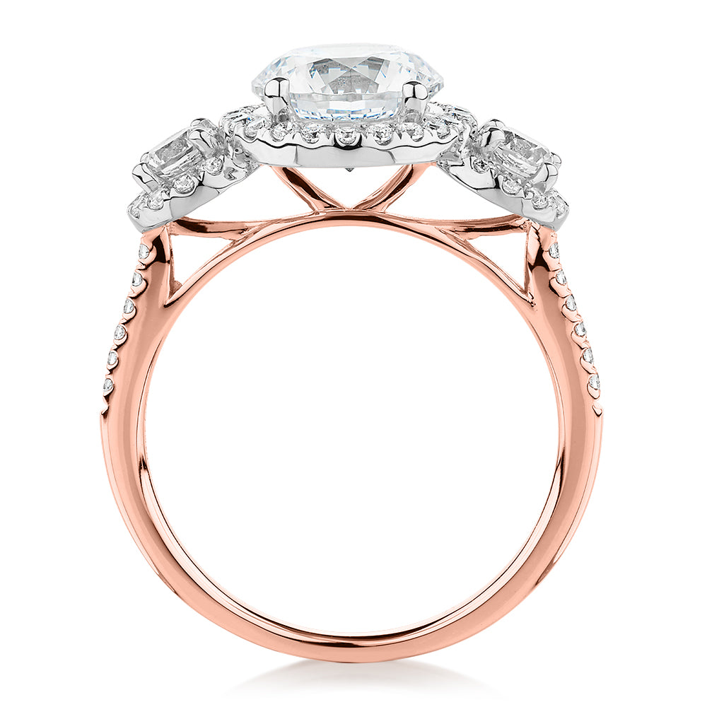 Three stone ring with 2.68 carats* of diamond simulants in 10 carat rose and white gold