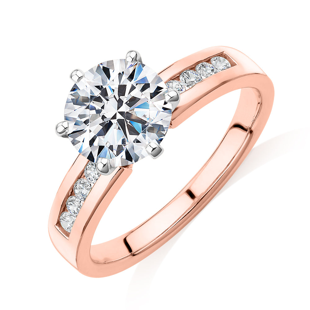 Round Brilliant shouldered engagement ring with 2.2 carats* of diamond simulants in 14 carat rose and white gold