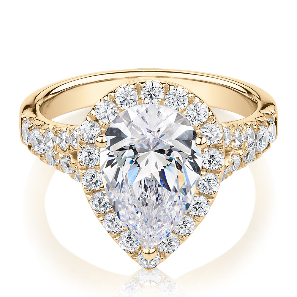 Pear and Round Brilliant halo engagement ring with 3.81 carats* of diamond simulants in 10 carat yellow gold