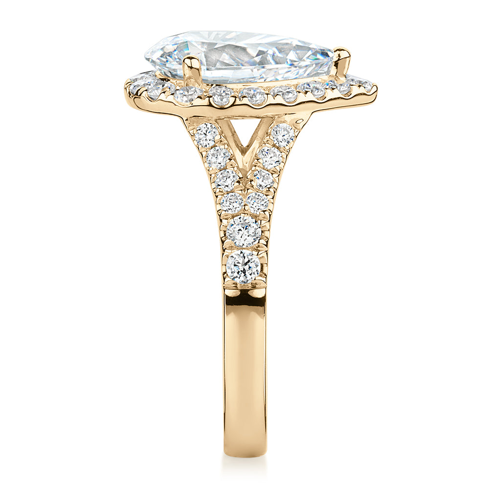 Pear and Round Brilliant halo engagement ring with 3.81 carats* of diamond simulants in 10 carat yellow gold
