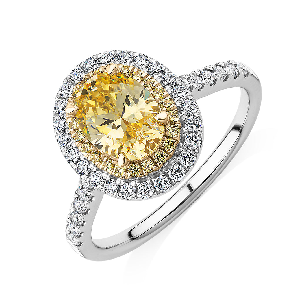 Oval and Round Brilliant halo engagement ring with 1.68 carats* of diamond simulants in 10 carat white and yellow gold