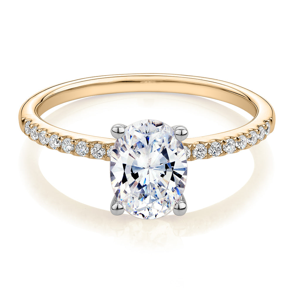 Oval and Round Brilliant shouldered engagement ring with 1.35 carats* of diamond simulants in 14 carat yellow and white gold