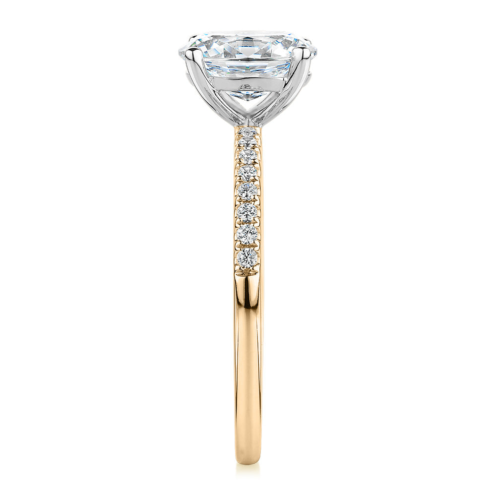 Oval and Round Brilliant shouldered engagement ring with 1.35 carats* of diamond simulants in 14 carat yellow and white gold
