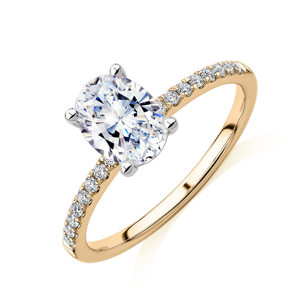 Oval and Round Brilliant shouldered engagement ring with 1.35 carats* of diamond simulants in 14 carat yellow and white gold