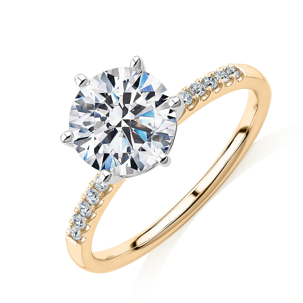 Round Brilliant shouldered engagement ring with 2.12 carats* of diamond simulants in 14 carat yellow and white gold