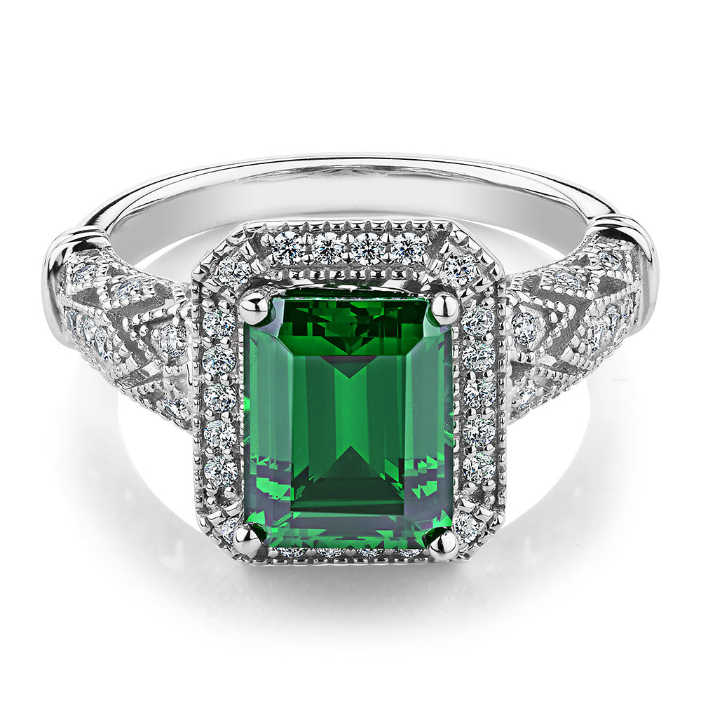 Dress ring with 9x7mm emerald simulant and 0.27 carats* of diamond simulants in 10 carat white gold