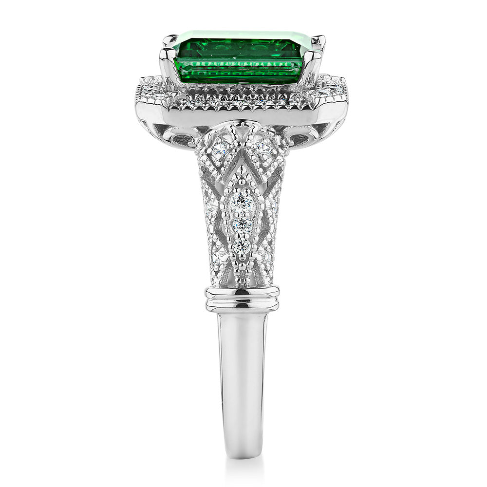 Dress ring with 9x7mm emerald simulant and 0.27 carats* of diamond simulants in 10 carat white gold
