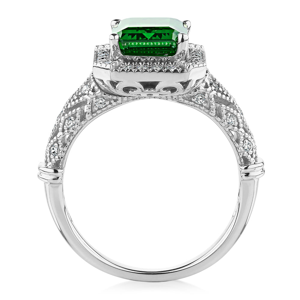 Dress ring with 9x7mm emerald simulant and 0.27 carats* of diamond simulants in 10 carat white gold