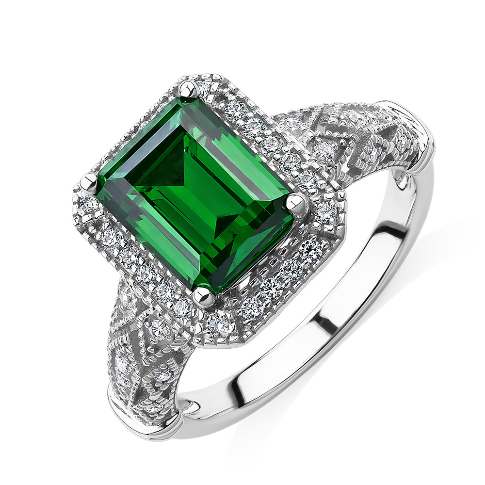 Dress ring with 9x7mm emerald simulant and 0.27 carats* of diamond simulants in 10 carat white gold