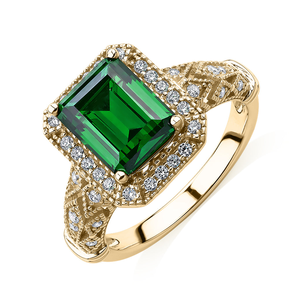 Dress ring with 9x7mm emerald simulant and 0.27 carats* of diamond simulants in 10 carat yellow gold