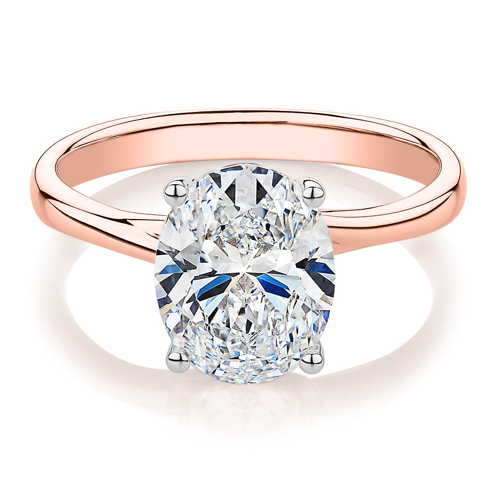 Oval solitaire engagement ring with 2.54 carat* diamond simulant in 14 carat rose and white gold