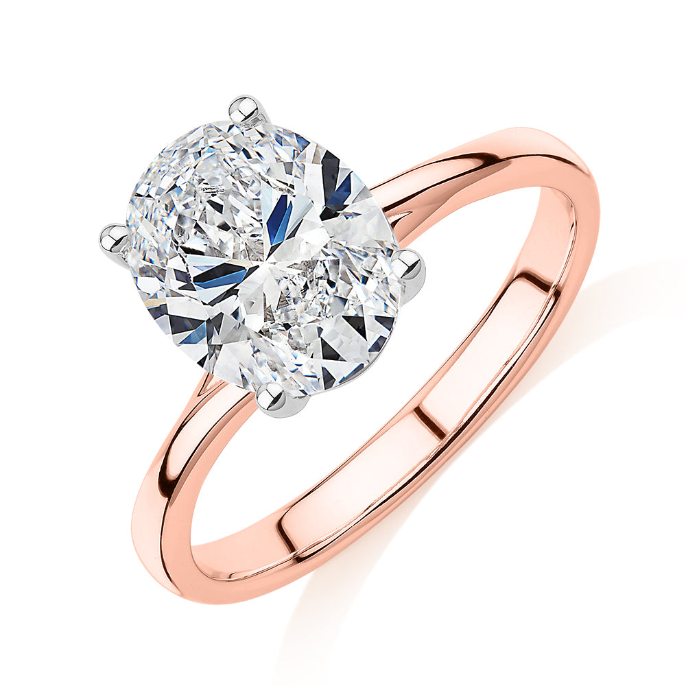 Oval solitaire engagement ring with 2.54 carat* diamond simulant in 14 carat rose and white gold