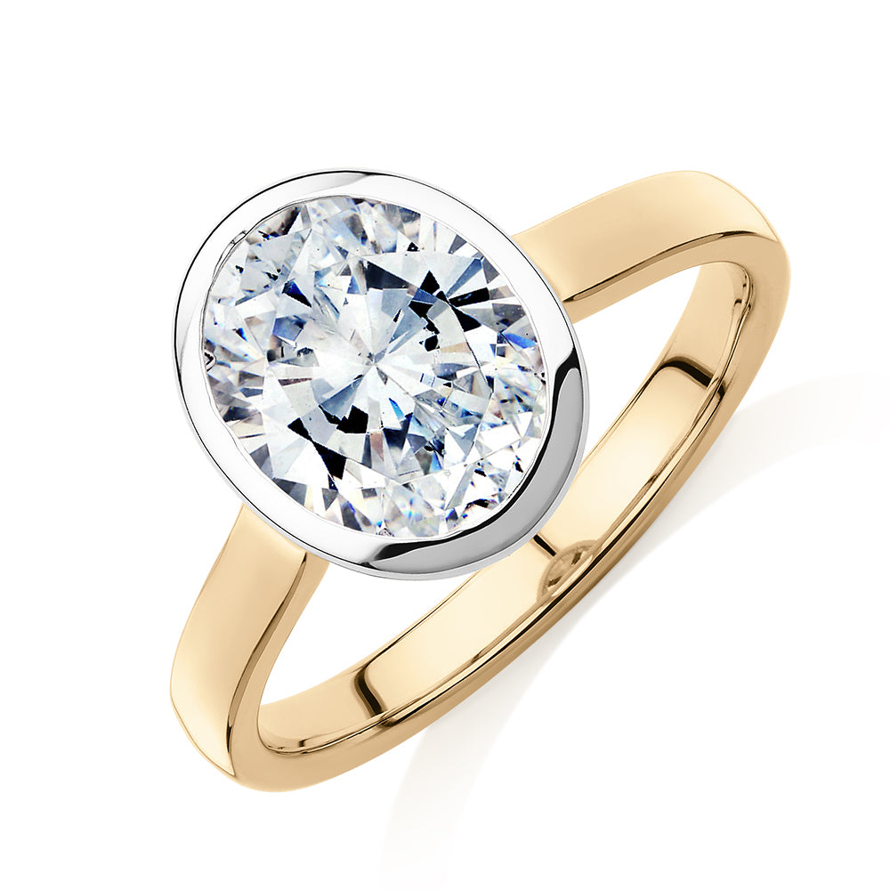 Oval solitaire engagement ring with 2.54 carat* diamond simulant in 14 carat yellow and white gold