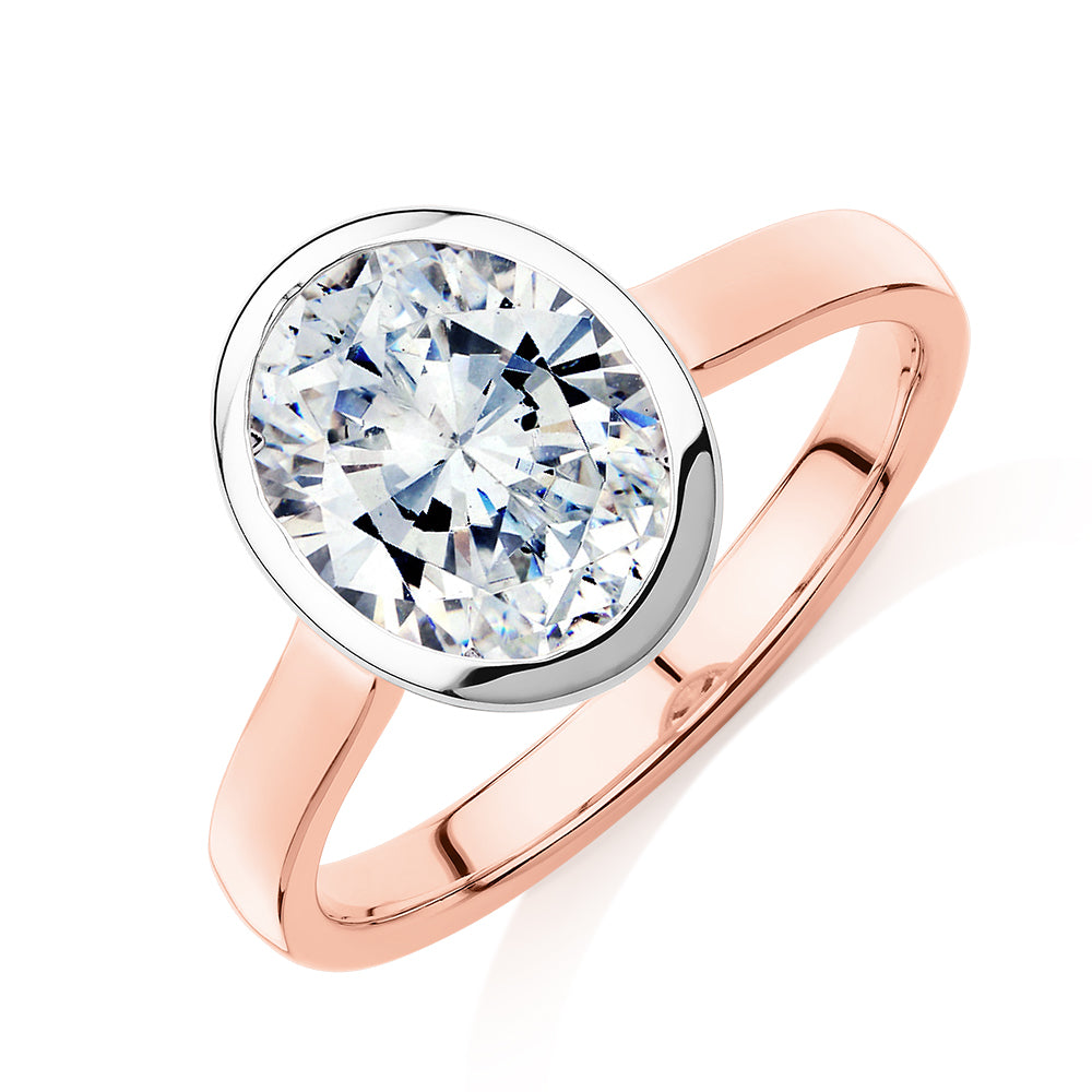 Oval solitaire engagement ring with 2.54 carat* diamond simulant in 14 carat rose and white gold