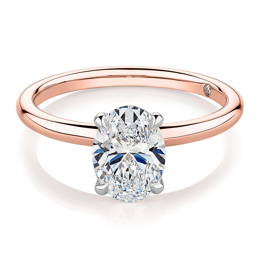 Signature Simulant Diamond 1.50 carat* oval solitaire engagement ring in 14 carat rose and white gold