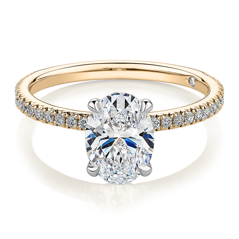 Signature Simulant Diamond 1.74 carat* TW oval and round brilliant shouldered engagement ring in 14 carat yellow and white gold
